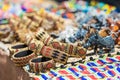 Colorful African Bracelets Bead Art with bright blurred colors of yellow pink and turquoise in the background Royalty Free Stock Photo