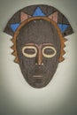 Colorful African mask on a stone wall background