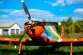 Colorful airplane parked on the grass at the airfield Royalty Free Stock Photo