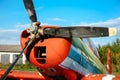 Colorful airplane parked on the grass at the airfield Royalty Free Stock Photo