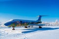 Colorful airplane in snowy countryside. Modern aircraft