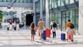 Colorful airport scene of travelers with their luggage at Frankfurt Airport and High Speed Train Terminal