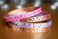 colorful allergy wristbands scattered on a rose gold metal sheet