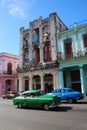 Colorful Almendrones, old Cars in a large avenue in La Havana, Cuba, with colorful buildings Royalty Free Stock Photo
