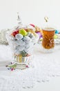 Colorful almond candies in the stylish,crystal candy bowl on the white table with Turkish Tea