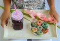 Colorful american donuts and fresh cherry juice served for breakfast