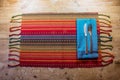 Colorful American Southwest inspired dinner place setting on a rustic wood table
