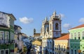 Colorful and ancient colonial houses facades and historic church towers in baroque and colonial style