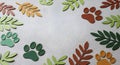 Colorful Animal Footprints and Leaf Shapes Decor on Light Gray Surface Royalty Free Stock Photo