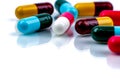 Colorful antibiotic capsule pills on white background. Pharmaceutics concept. Antibiotic drug resistance. Pharmaceutical industry.