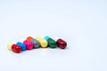 Colorful of antibiotic capsules pills in a row on white background with copy space. Royalty Free Stock Photo