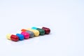 Colorful of antibiotic capsules pills in a row on white background with copy space. Royalty Free Stock Photo