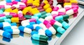 Colorful of antibiotic capsules pills with shadows on stainless steel drug tray