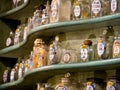Colorful antique flasks on wooden shelf