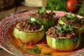 Colorful and appetizing stuffed zucchini rounds on a ceramic plate