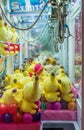 Colorful arcade game toy claw crane machine where people can win toys and other prizes Royalty Free Stock Photo