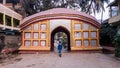 A colorful arched gateway in the traditional Assamese style architecture at the ancient