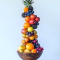 Colorful stacked fruits against white background for healthy eating concepts Royalty Free Stock Photo