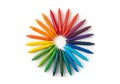 Colorful array of crayons arranged in a circular pattern on a white Royalty Free Stock Photo