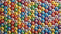 A colorful array of cylindrical batteries arranged in a closely packed, repetitive pattern. Generative AI Royalty Free Stock Photo