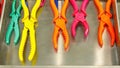 A colorful array of 3Dprinted tools including pliers and ters arranged neatly on a metal shelf each displaying intricate Royalty Free Stock Photo