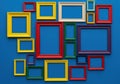 A colorful array of empty picture frames against a blue background Royalty Free Stock Photo