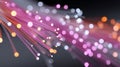 A colorful array of fiber optic cables with glowing ends against a dark background Royalty Free Stock Photo