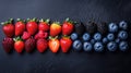 Colorful array of fresh berries arranged in horizontal rows Royalty Free Stock Photo