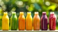 Colorful array of fresh fruit juices in glass bottles outdoors. Vibrant, healthy drink options in summer setting Royalty Free Stock Photo