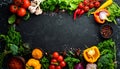Vibrant Assortment of Fresh Vegetables and Spices Forming a Border on Dark Surface herbs Royalty Free Stock Photo