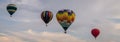 Colorful array of hot air balloons float through the sky at dusk at Warren County Farmer`s Fair on 8/1/17