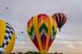 Colorful array of hot air balloons float through the sky at dusk at Warren County Farmer`s Fair on 8/1/17