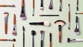 Colorful array of makeup brushes arranged on a soft pastel background Royalty Free Stock Photo