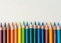 Colorful array of sharpened pencils lined up against a white background Royalty Free Stock Photo