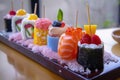 A colorful array of sushi pieces beautifully arranged on a tray resting on a table, showcasing the intricate