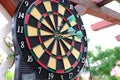 Colorful arrows hit the dartboard, hit right on target, electronic scoreboard counts the players` points, the concept of sports