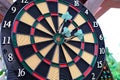 Colorful arrows hit the dartboard, hit right on target, electronic scoreboard counts the players` points, the concept of sports