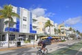 Colorful art deco hotels and cyclist on Ocean Drive in Miami Beach, Florida