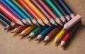 Colorful art pencils arranged in a circle on a table Royalty Free Stock Photo