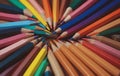 Colorful art pencils arranged in a circle on a table Royalty Free Stock Photo