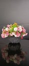 Colorful artificial flower centerpiece against a dark background Royalty Free Stock Photo
