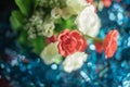 Colorful artificial white and red rose flowers bunch on blue bokeh background Royalty Free Stock Photo