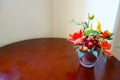 Colorful Artificial Yellow Orange Rose Vase on Wooden Table and Royalty Free Stock Photo
