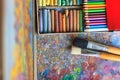 Colorful artist palette with pastel and oil brushes in art studio Royalty Free Stock Photo