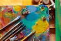 Colorful artists palette with pastel and oil brushes in art studio Royalty Free Stock Photo