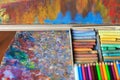 Colorful artist palette with pastel and oil brushes in art studio Royalty Free Stock Photo