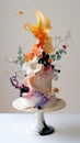 Colorful artistic cake with whimsical decorative elements on a stand Royalty Free Stock Photo