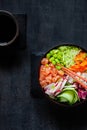 Colorful Asian trendy food, sushi poke bowl with rice, cucumber, salmon, carrot, edamame beans and soy sauce. Top view, close up Royalty Free Stock Photo