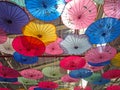 Colorful asian umbrellas hanged on a ceiling