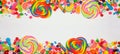 Colorful candies, above view double border with a white banner background
